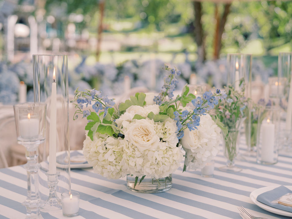 Blue and white centerpiece on wedding reception table. Wedding done by HeatherLily at a central Ohio lake house